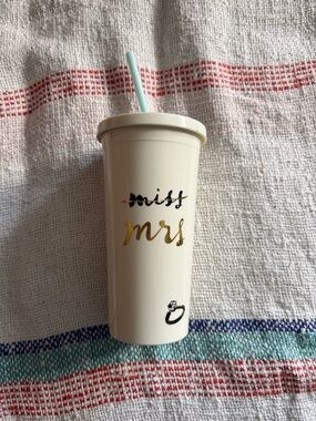 kate spade cream tumbler with gold "mrs" lettering and light blue straw